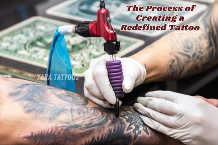 A professional artist carefully transforms an old tattoo into a new detailed design