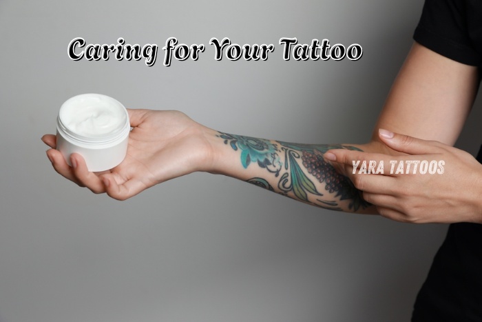 Yara Tattoos in Coimbatore proper tattoo aftercare with soothing cream applied on a freshly inked forearm tattoo